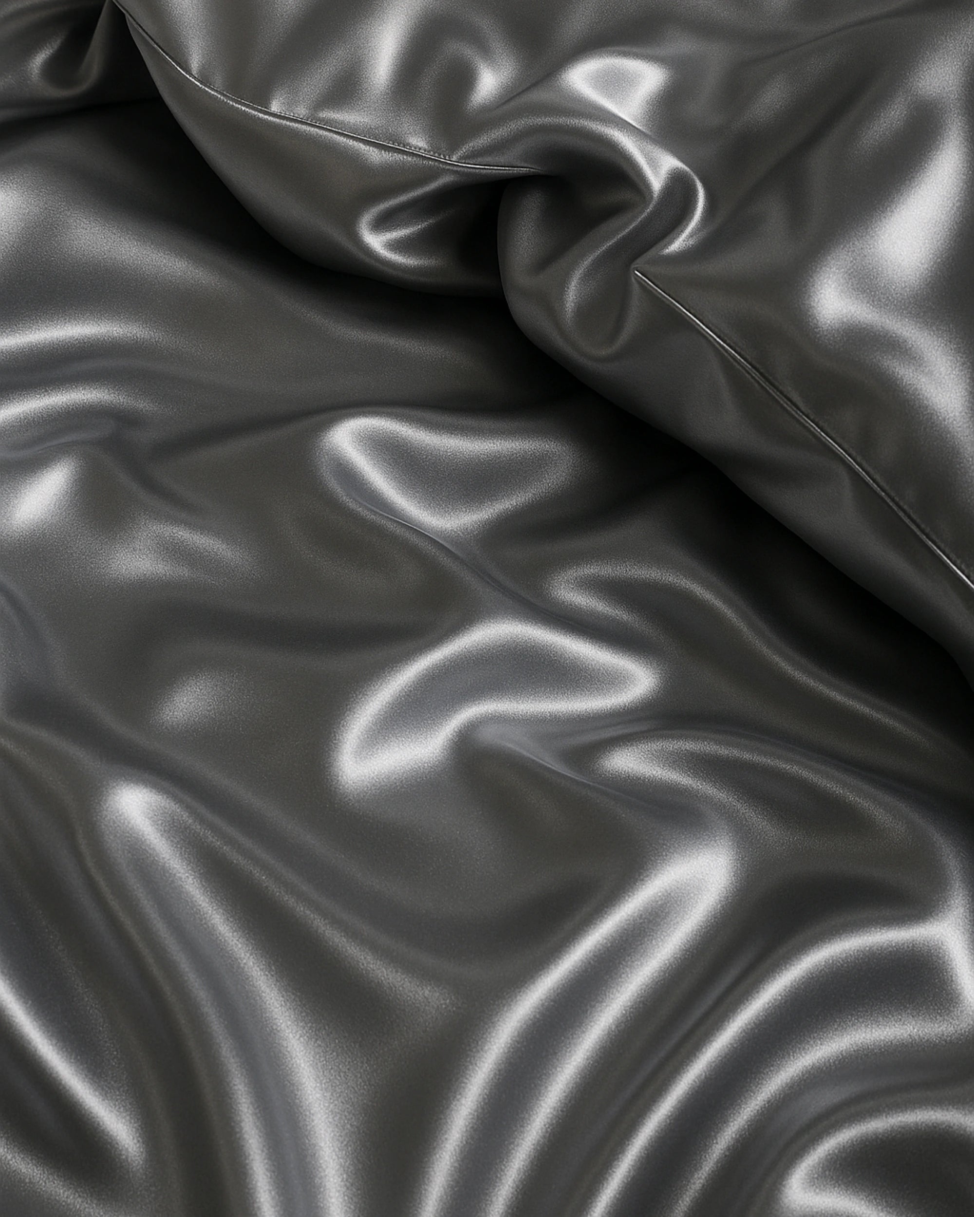 Close-up of Moonlight Silver Satin Fitted Sheets showcasing their luxurious sheen and smooth texture.