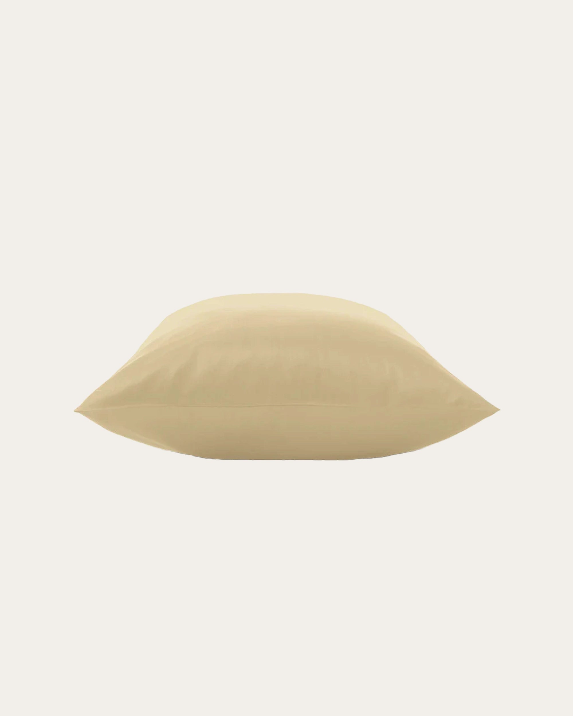 Beige satin pillowcase on a bed, adding elegance and comfort to your bedroom decor.