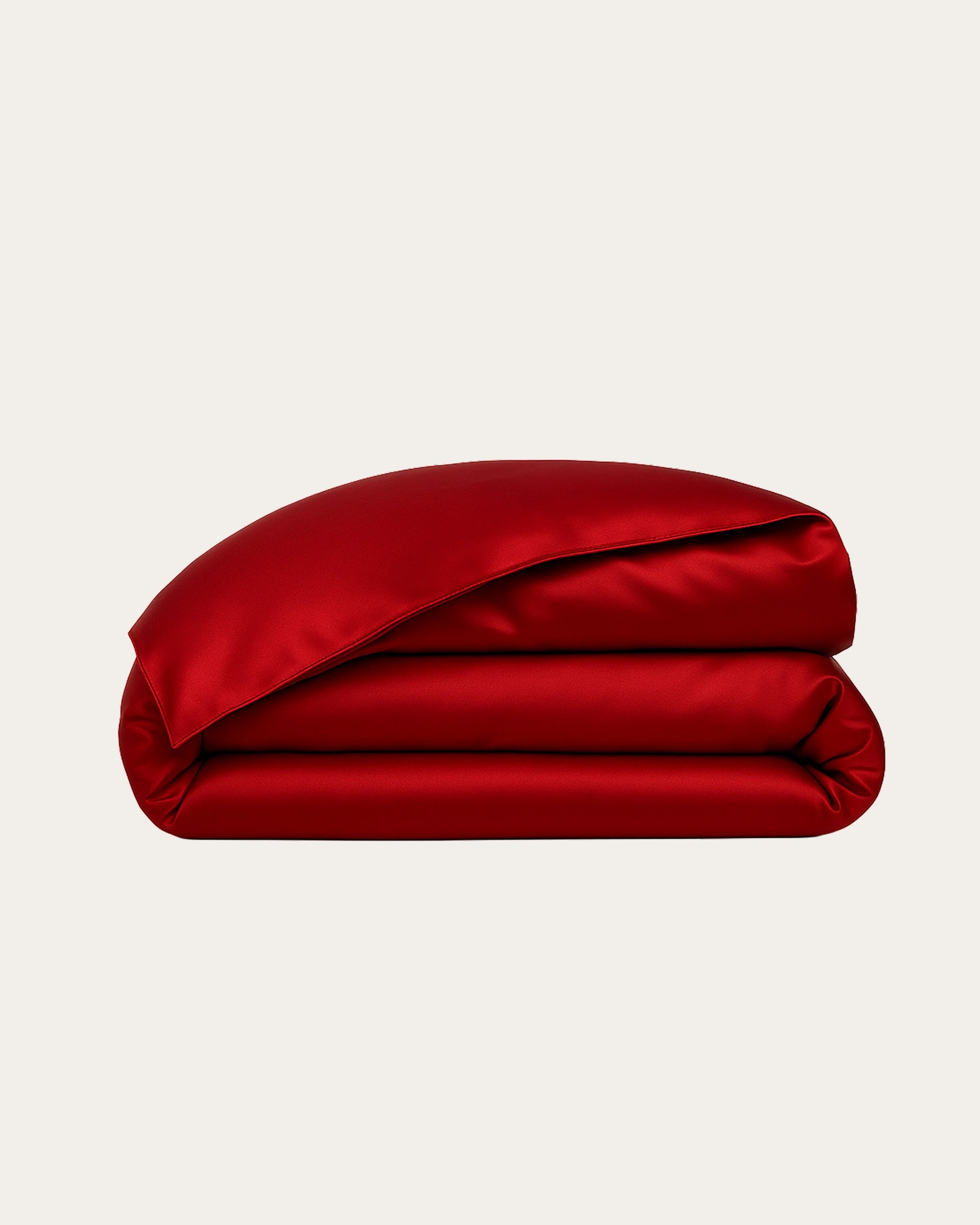 Imperial Red Satin Duvet Cover folded, showcasing its smooth, luxurious satin texture for a cozy and elegant bedroom decor.