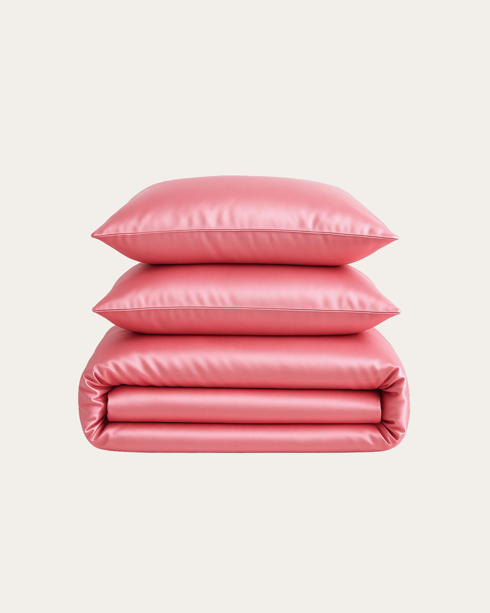 Blossom Pink Satin Bedding Set with stacked pillows and duvet, adding elegance to any bedroom.