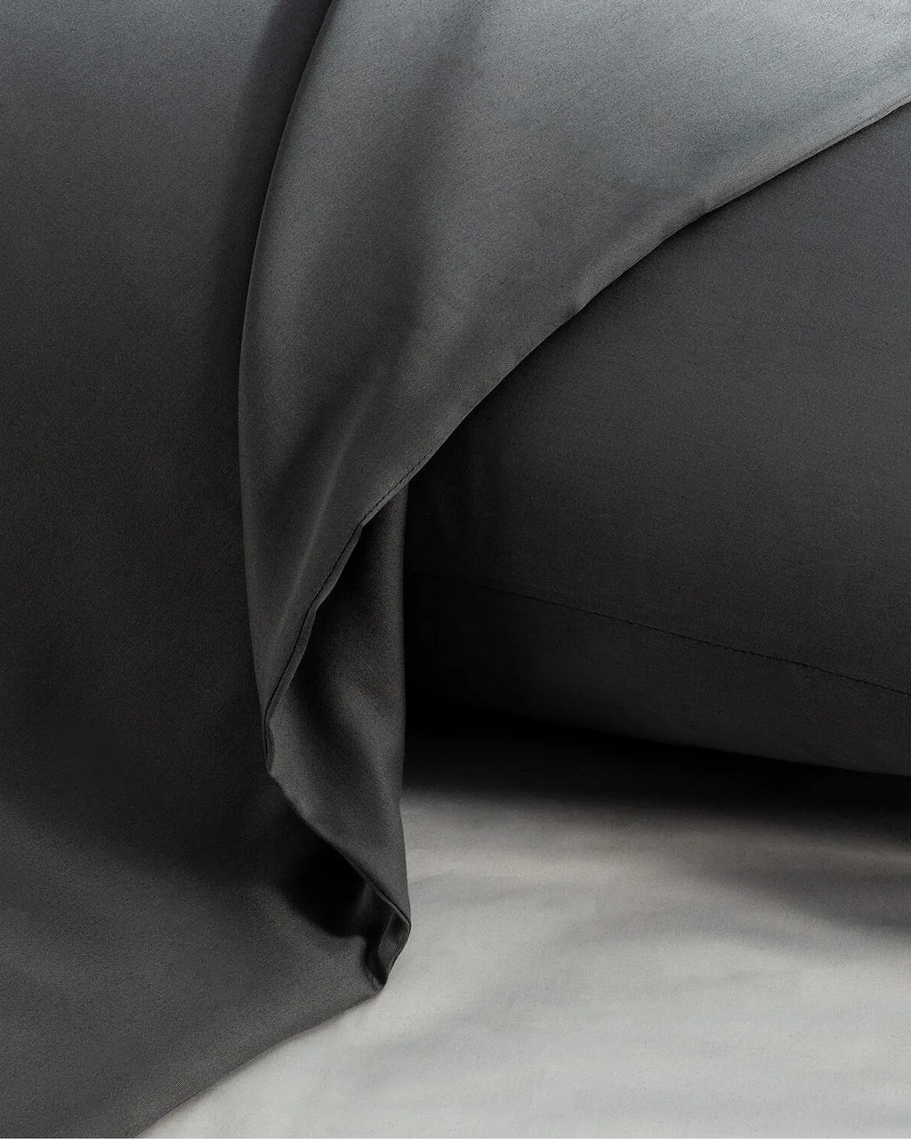 Close-up of Moonlight Silver Satin Fitted Sheets showcasing their sleek design and soft, wrinkle-free fabric.